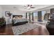 Main bedroom with dark wood floors, ceiling fan, and large windows at 959 W Myrtle Dr, Chandler, AZ 85248