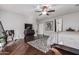 Main bedroom with dark wood floors, ceiling fan, and large windows at 959 W Myrtle Dr, Chandler, AZ 85248