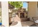 Outdoor kitchen featuring a built-in grill and fireplace at 959 W Myrtle Dr, Chandler, AZ 85248