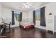 Well-lit bedroom with dark wood floors, window coverings and a comfortable bed at 959 W Myrtle Dr, Chandler, AZ 85248