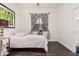 Bright bedroom with dark wood floors, window coverings and a plush bed at 959 W Myrtle Dr, Chandler, AZ 85248