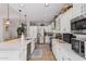 Spacious kitchen with white cabinets, stainless steel appliances, and expansive island at 959 W Myrtle Dr, Chandler, AZ 85248