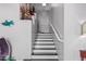 Indoor staircase with dark wood steps and white railings at 959 W Myrtle Dr, Chandler, AZ 85248