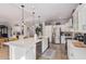 Modern kitchen with white cabinets, large island, and stainless steel appliances at 959 W Myrtle Dr, Chandler, AZ 85248