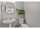 Clean bathroom with pedestal sink, toilet, and octagonal mirror at 959 W Myrtle Dr, Chandler, AZ 85248