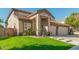 Two-story house with a three-car garage and lush landscaping at 959 W Myrtle Dr, Chandler, AZ 85248