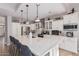 Modern kitchen with white cabinets, large island, and stainless steel appliances at 959 W Myrtle Dr, Chandler, AZ 85248