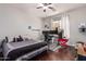 Modern bedroom with dark wood floors, a workspace and a comfortable bed at 959 W Myrtle Dr, Chandler, AZ 85248