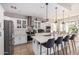 Modern kitchen with white cabinets, large island, and stainless steel appliances at 959 W Myrtle Dr, Chandler, AZ 85248