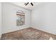 Well-lit bedroom featuring a large arched window and ceiling fan at 6618 W Maya Way, Phoenix, AZ 85083