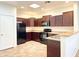 Modern kitchen with dark wood cabinets and appliances at 8940 W Olive Ave # 134, Peoria, AZ 85345