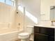Bathroom with tub, toilet and dark vanity at 8940 W Olive Ave # 134, Peoria, AZ 85345