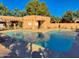 Community pool with surrounding lounge chairs at 8940 W Olive Ave # 134, Peoria, AZ 85345