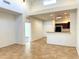 Open kitchen with dark wood cabinets and tile floors at 8940 W Olive Ave # 134, Peoria, AZ 85345