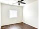 Bright bedroom with dark wood floors, ceiling fan, and window blinds at 8940 W Olive Ave # 134, Peoria, AZ 85345