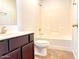 Clean bathroom with tub, toilet and dark brown vanity at 8940 W Olive Ave # 134, Peoria, AZ 85345