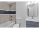 Clean bathroom with gray vanity, white toilet, and updated shower/tub combo at 8614 E Windsor Ave, Scottsdale, AZ 85257