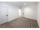 Spacious bedroom with gray carpet and neutral walls at 310 N Brower Rd, Maricopa, AZ 85139