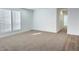 Bright bedroom with large windows and carpeted floor at 310 N Brower Rd, Maricopa, AZ 85139