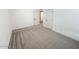 Well-lit bedroom with gray carpet and neutral walls at 310 N Brower Rd, Maricopa, AZ 85139
