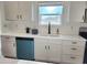 White kitchen with teal dishwasher and a double sink at 310 N Brower Rd, Maricopa, AZ 85139