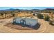 Aerial view of a single-story home in a desert setting at 310 N Brower Rd, Maricopa, AZ 85139