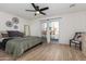 Main bedroom with a king-size bed, sliding door to backyard, and ceiling fan at 1612 E Julie Dr, Tempe, AZ 85283