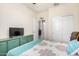 Bedroom with a teal colored bedspread and a built-in TV stand at 1115 E Tyler Ln, Casa Grande, AZ 85122