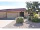 Front view of the house with a two-car garage and well-maintained landscaping at 4901 E Magic Stone Dr, Phoenix, AZ 85044