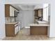 Kitchen with wood cabinets, laminate flooring, and a breakfast bar at 4901 E Magic Stone Dr, Phoenix, AZ 85044