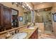 Spa-like bathroom with double vanity, large shower, and granite countertop at 10612 E Winter Sun Dr, Scottsdale, AZ 85262