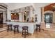 Custom bar with granite countertop, wood cabinetry, and seating at 10612 E Winter Sun Dr, Scottsdale, AZ 85262