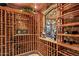 Custom-built wine cellar with ample storage for wine bottles at 10612 E Winter Sun Dr, Scottsdale, AZ 85262