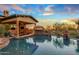 Inviting pool and spa with a waterfall feature and mountain views at 10612 E Winter Sun Dr, Scottsdale, AZ 85262