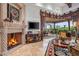 Stone fireplace with ornate mantel in a spacious living room at 10612 E Winter Sun Dr, Scottsdale, AZ 85262