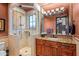 Elegant bathroom with a walk-in shower, granite vanity, and decorative chandelier at 10612 E Winter Sun Dr, Scottsdale, AZ 85262