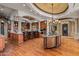 Gourmet kitchen with large island, wood cabinetry, and chandelier at 10612 E Winter Sun Dr, Scottsdale, AZ 85262