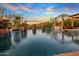 Expansive pool with fire bowls and a tranquil waterfall feature at 10612 E Winter Sun Dr, Scottsdale, AZ 85262