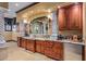 Bathroom with custom wood cabinets, granite countertops, and a wet bar at 10612 E Winter Sun Dr, Scottsdale, AZ 85262