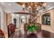 Elegant dining room featuring a large wood table, ornate chandelier, and decorative accents at 10612 E Winter Sun Dr, Scottsdale, AZ 85262