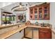Wet bar with granite countertop, wood cabinetry, and beverage cooler at 10612 E Winter Sun Dr, Scottsdale, AZ 85262