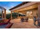 Spacious flagstone patio with seating area, offering stunning sunset views at 10612 E Winter Sun Dr, Scottsdale, AZ 85262