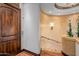 Elegant curved staircase with wrought iron railing and stone walls at 10612 E Winter Sun Dr, Scottsdale, AZ 85262