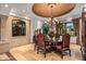 Elegant dining room with chandelier, large windows and ornate chairs at 10612 E Winter Sun Dr, Scottsdale, AZ 85262