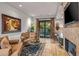 Relaxing sitting area with fireplace, comfortable seating, and access to a patio at 10612 E Winter Sun Dr, Scottsdale, AZ 85262