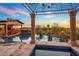 Resort-style pool with a pergola, spa, and stunning views at 10612 E Winter Sun Dr, Scottsdale, AZ 85262