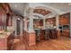 Large kitchen with island, granite countertops, and dark wood cabinets at 10612 E Winter Sun Dr, Scottsdale, AZ 85262