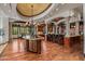 Gourmet kitchen with island, granite counters, custom cabinetry, and high-end appliances at 10612 E Winter Sun Dr, Scottsdale, AZ 85262