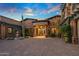 Elegant home with a large courtyard and gated entry at 10612 E Winter Sun Dr, Scottsdale, AZ 85262