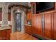 Butlers pantry with wine storage, custom cabinets and granite counters at 10612 E Winter Sun Dr, Scottsdale, AZ 85262